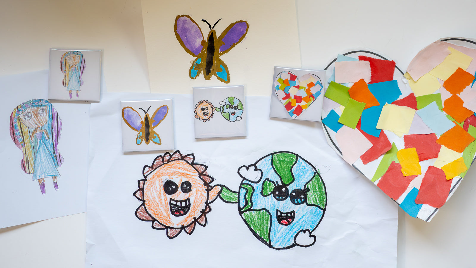 Display of childrens art works and the set of personalised photo magnets made with photos of the childrens art work